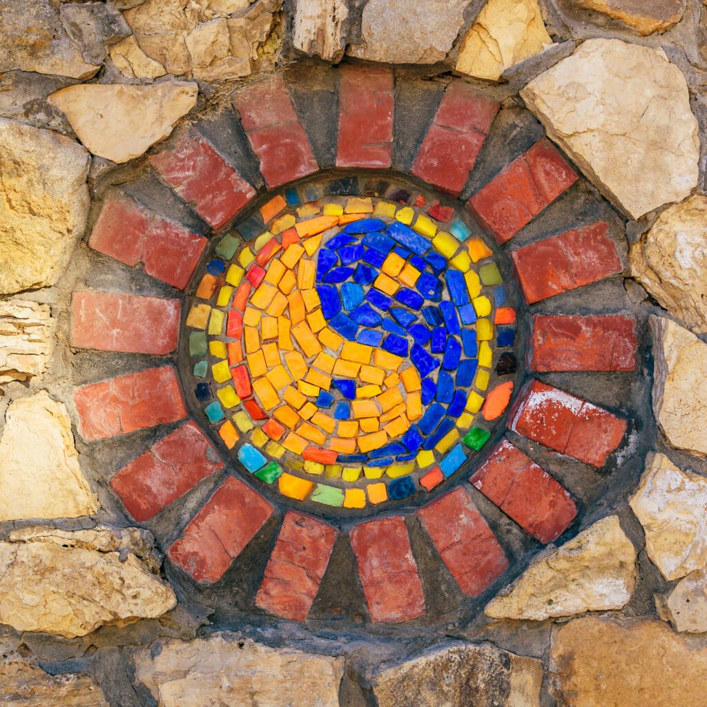 Mosaic symbol of Yin and yang on stone wall.